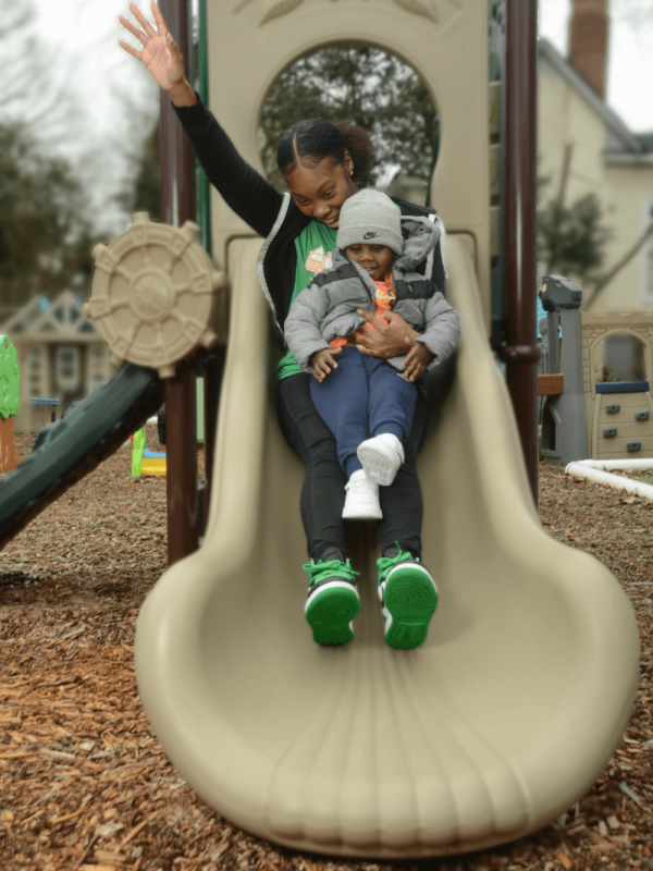 toddler-and-teacher-on-slide(1)